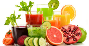 Glasses With Fresh Organic Vegetable And Fruit Juices On White